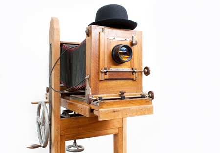 Wooden retro photo camera and bowler hatの写真素材