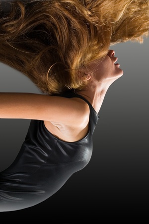 Profile of beautiful dancer with fluttering hairの写真素材