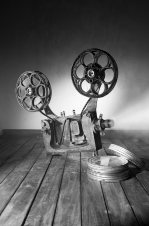 Movie projector with the film on the wooden floorの写真素材