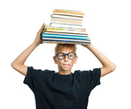 Undistracted schoolboy with books on her headの写真素材
