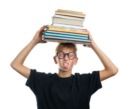 Tired schoolboy with books on her headの写真素材