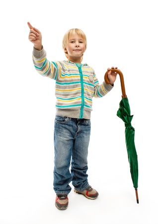 Little boy with a closed green umbrellaの写真素材