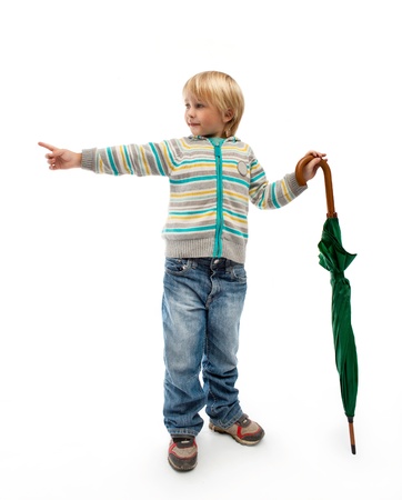 Little boy with a closed green umbrellaの写真素材