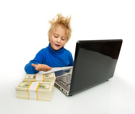 Little boy with computer end moneyの写真素材