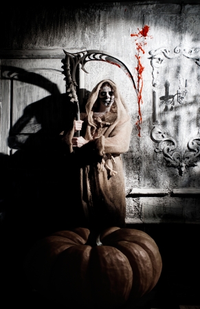 Scary death with a scythe in the old houseの写真素材