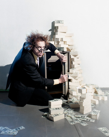 Crazy banker with bunch of moneyの写真素材