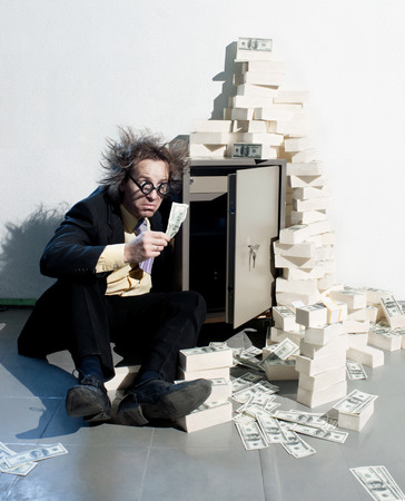 Crazy banker with bunch of moneyの写真素材