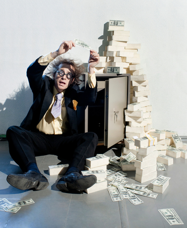 Crazy banker with bunch of moneyの写真素材