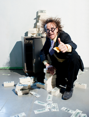 Crazy banker with bunch of moneyの写真素材