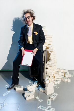 Crazy banker with bunch of moneyの写真素材