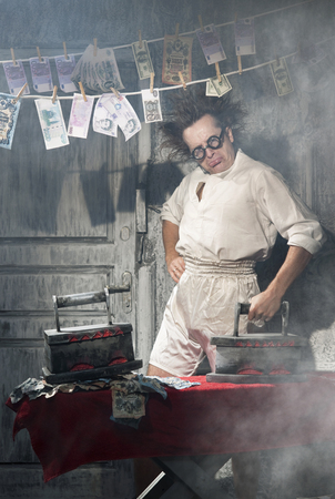 Crazy counterfeiter dries and ironed currencyの写真素材