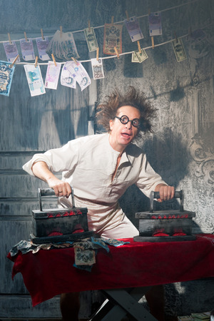 Crazy counterfeiter dries and ironed currencyの写真素材