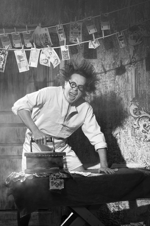 Crazy counterfeiter dries and ironed currencyの写真素材