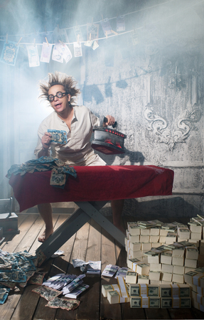 Crazy counterfeiter dries and ironed currencyの写真素材