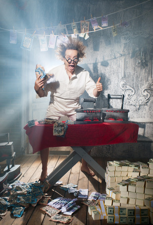 Crazy counterfeiter dries and ironed currencyの写真素材