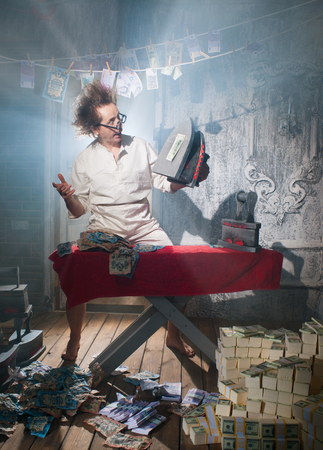 Crazy counterfeiter dries and ironed currencyの写真素材