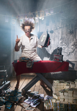 Crazy counterfeiter dries and ironed currencyの写真素材