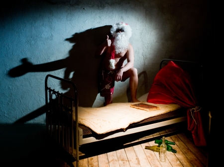 Drunk Santa Claus in the room with bedの写真素材