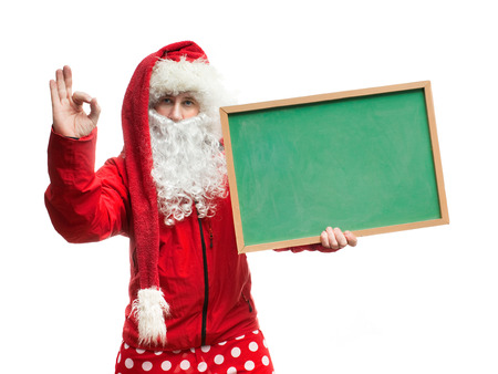 Funny Santa Claus in a red blazer with a blackboardの写真素材