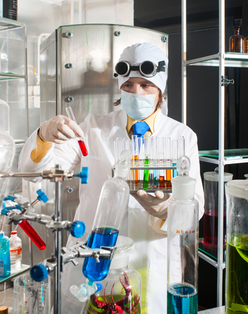 Scientist chemist puts science experiment in laboratoryの写真素材