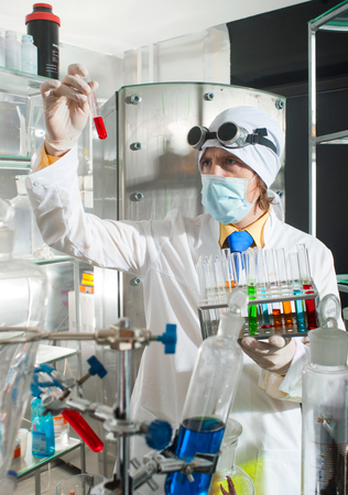 Scientist chemist puts science experiment in laboratoryの写真素材