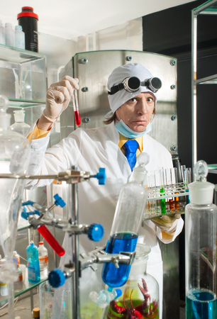 Scientist chemist puts science experiment in laboratoryの写真素材