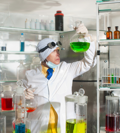 Scientist chemist puts science experiment in laboratoryの写真素材