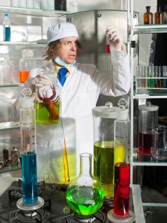 Scientist chemist puts science experiment in laboratoryの写真素材