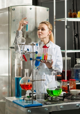 Scientist chemist puts science experiment in laboratoryの写真素材