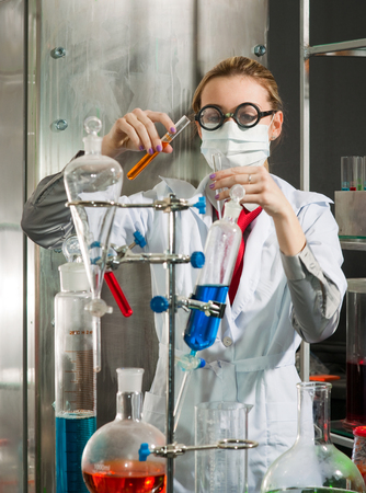 Scientist chemist puts science experiment in laboratoryの写真素材