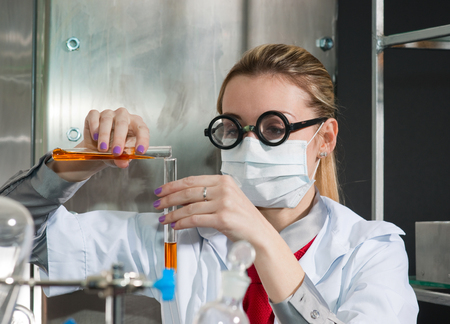 Scientist chemist puts science experiment in laboratoryの写真素材