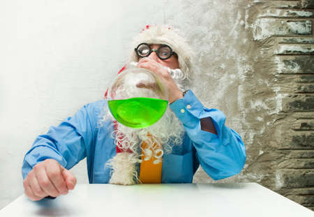 Santa Claus with glasses drinking from a vessel
