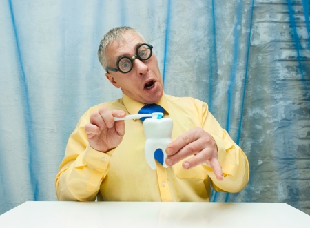 Professor of Dentistry with model of tooth and  toothbrushの写真素材