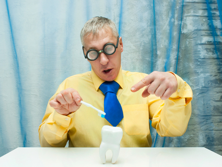 Professor of Dentistry with model of tooth and  toothbrushの写真素材