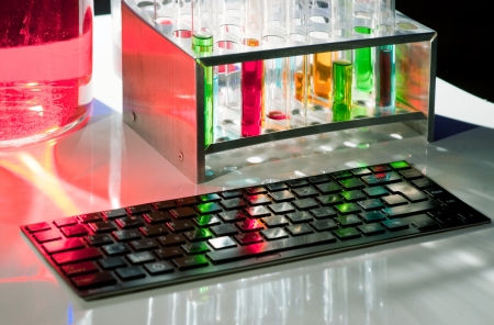 Computer keyboard and color vials with beautiful lightingの写真素材