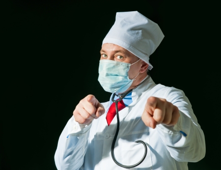 Doctor wearing a mask from the flu with stethoscopeの写真素材