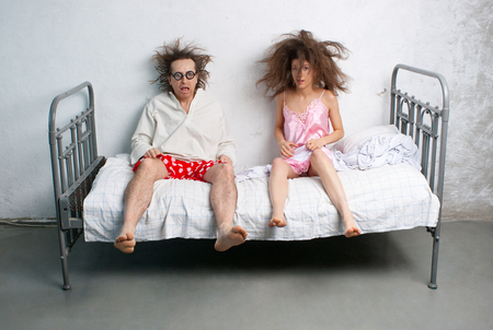 Funny husband and wife in the bedの写真素材