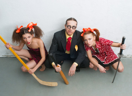 Aggressive man and women sitting on the floorの写真素材