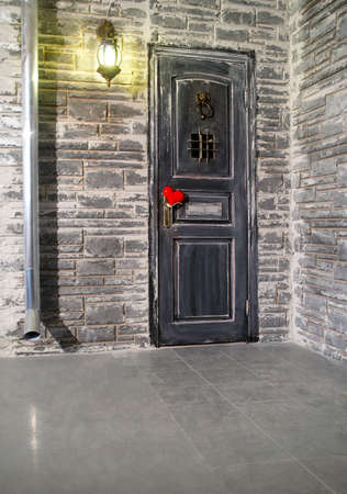 Wall of the house with a door in the foregroundの写真素材