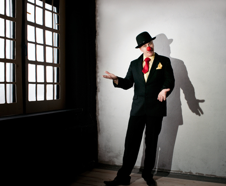 Actor in a black suit in the room with window の写真素材