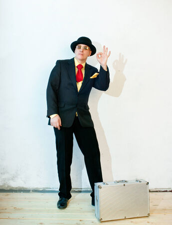 Businessman in black suit with a suitcaseの写真素材