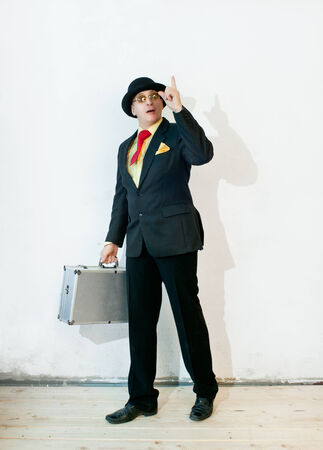 Businessman in black suit with a suitcaseの写真素材
