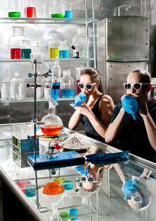 Chemists in the laboratory with a variety of bottlesの写真素材