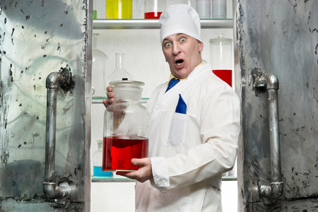 Crazy chemist with the beaker in the laboratoryの写真素材