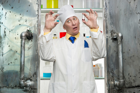 Crazy chemist with the vials in the laboratoryの写真素材