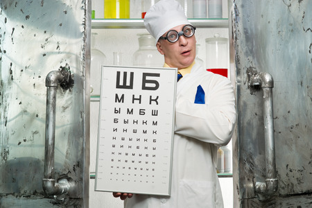 Funny oculist with a table in the laboratoryの写真素材