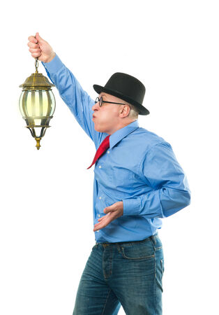 Attractive man with a lantern in his handの写真素材