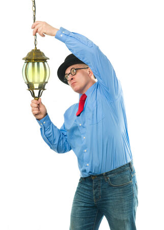 Attractive man with a lantern in his handsの写真素材