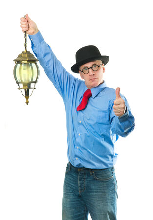 Attractive man with a lantern in his handの写真素材