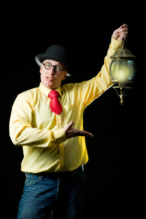 Man with a lamp in his hand at nightの写真素材